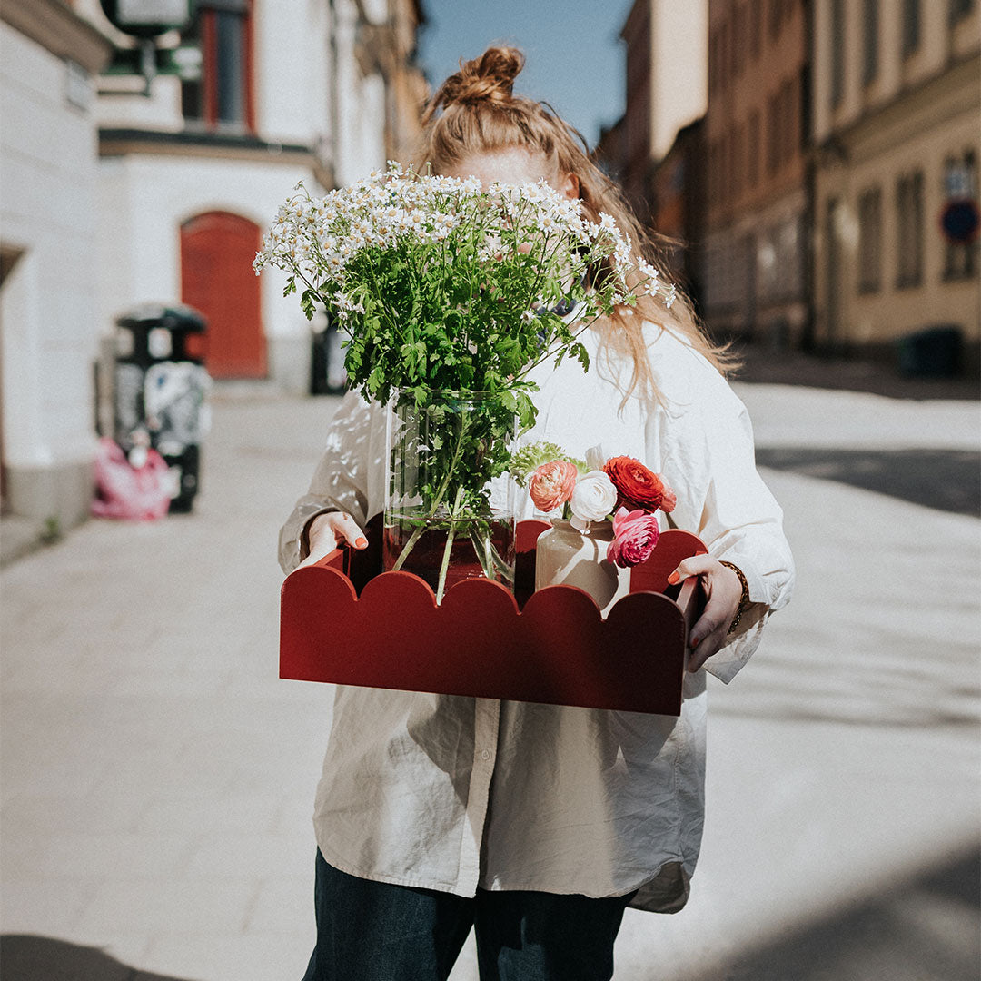 bricka i burgundy färg fylld med blommor